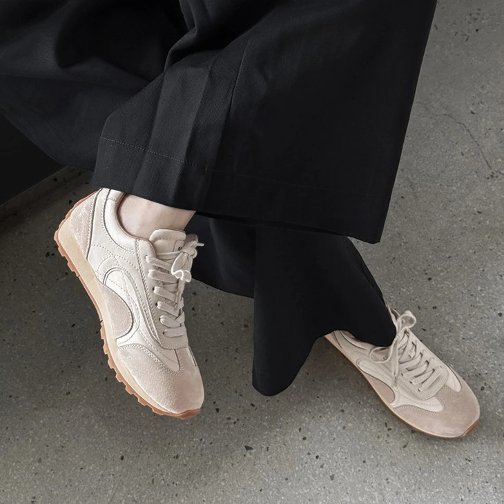 Off-white suede retro runner sneakers on foot, front view
