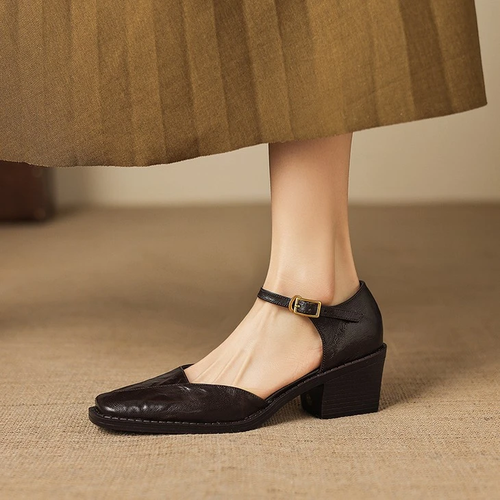 Black square toe Mary Jane heels worn with a skirt